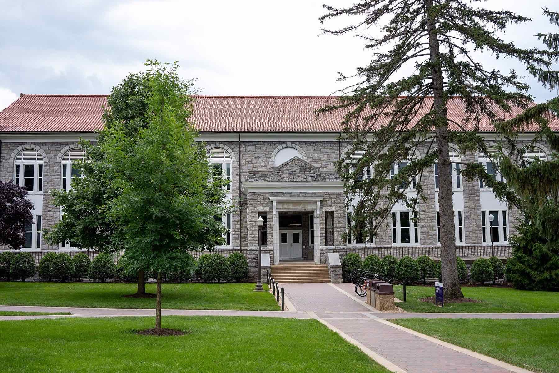 Harrison Hall, a limestone building with a red tile roof on the James Madison University quad
